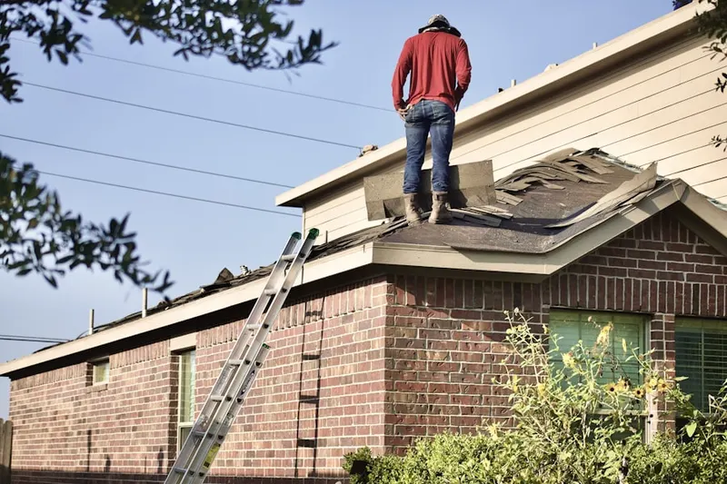 Professional roofer working on a residential roof in Lower Salford